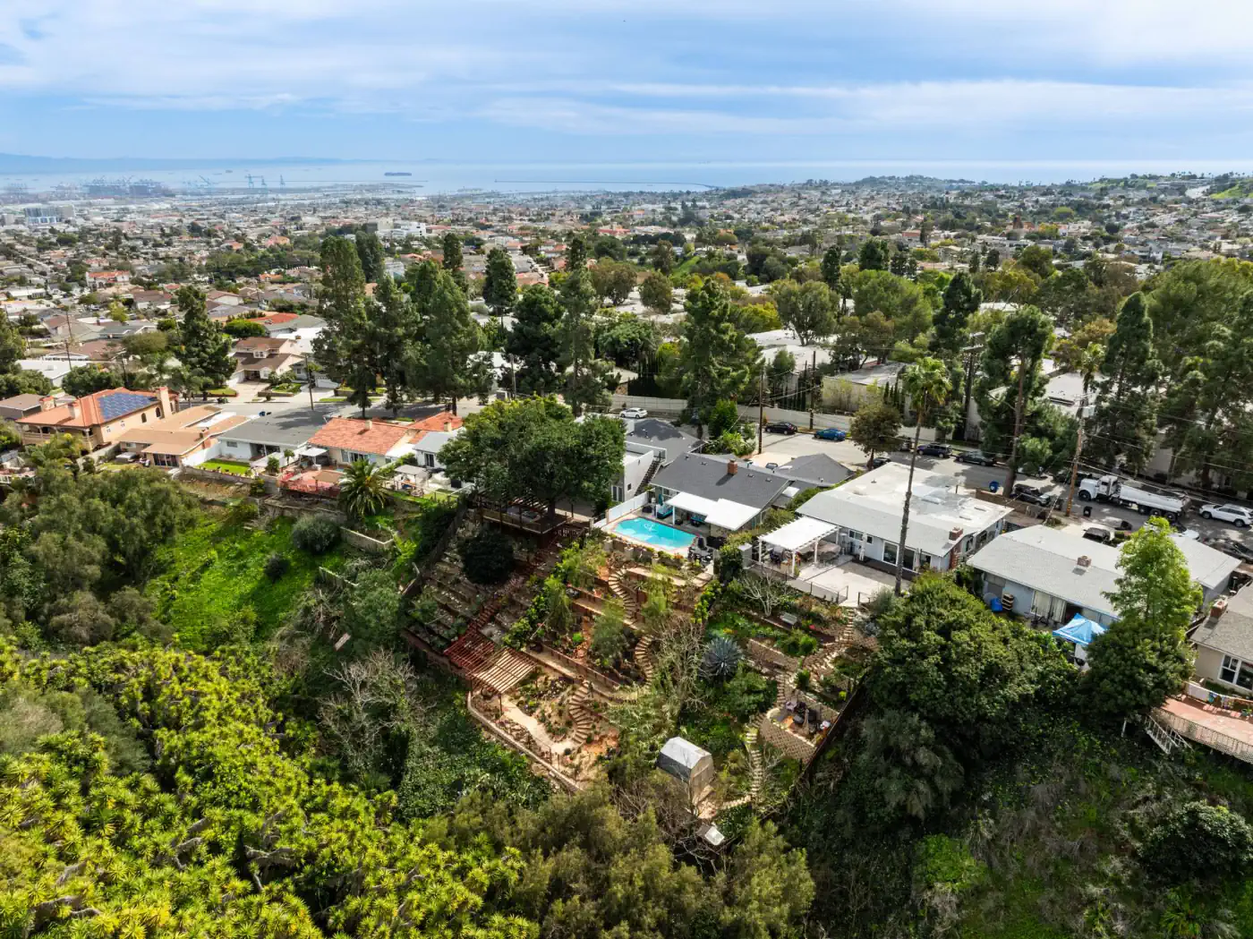 Aerial view over a Los Angeles County hillside neighborhood toward the coast