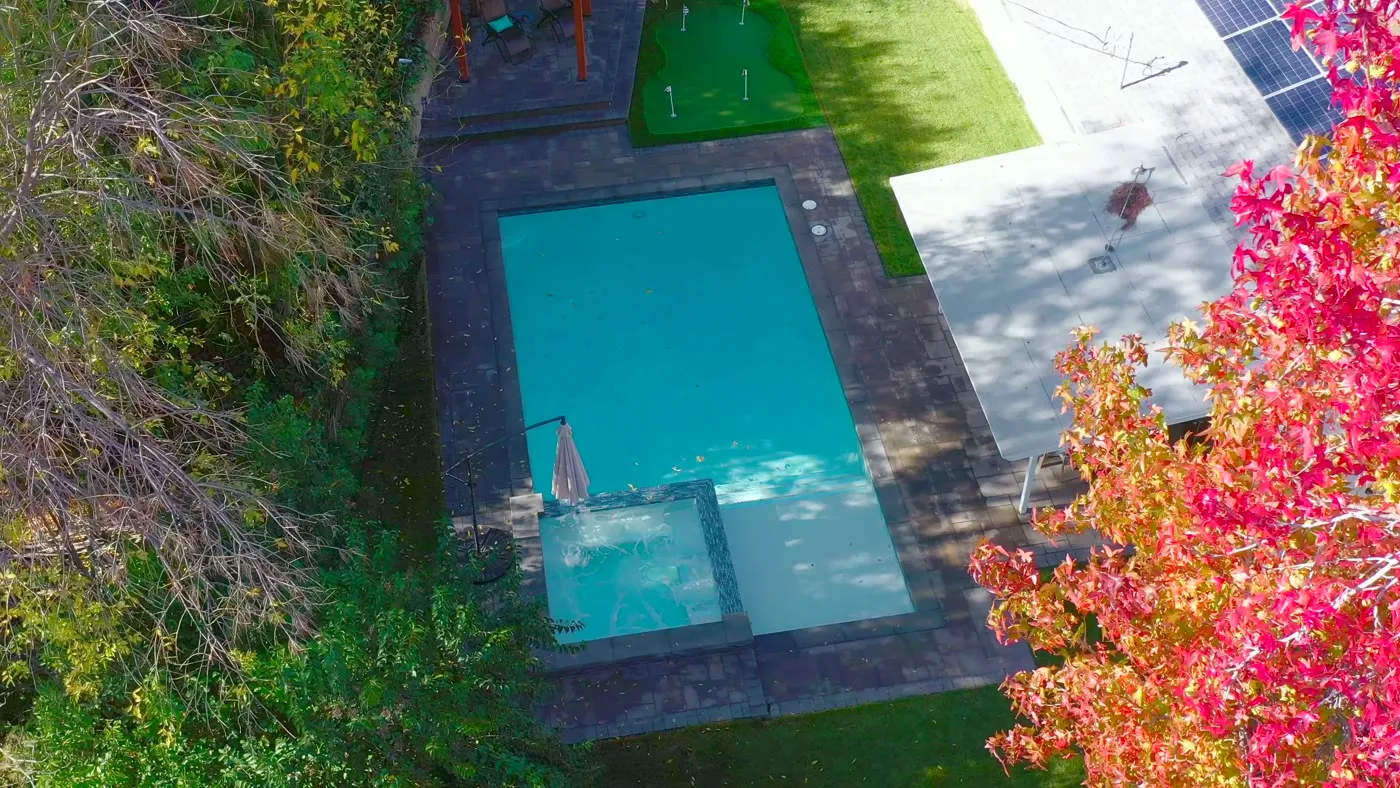 Overhead view of the pool, spa, and paver deck