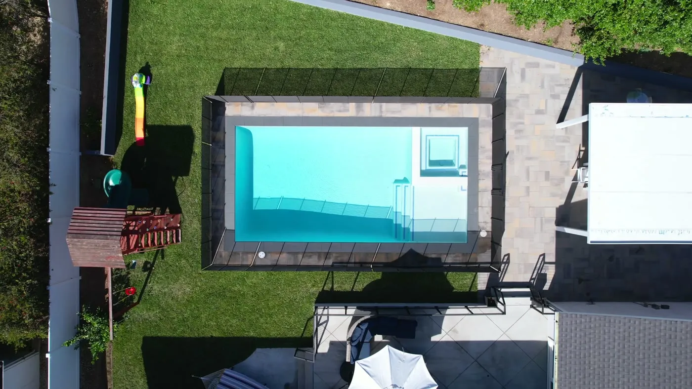 Overhead view of the pool shell, coping, and steps
