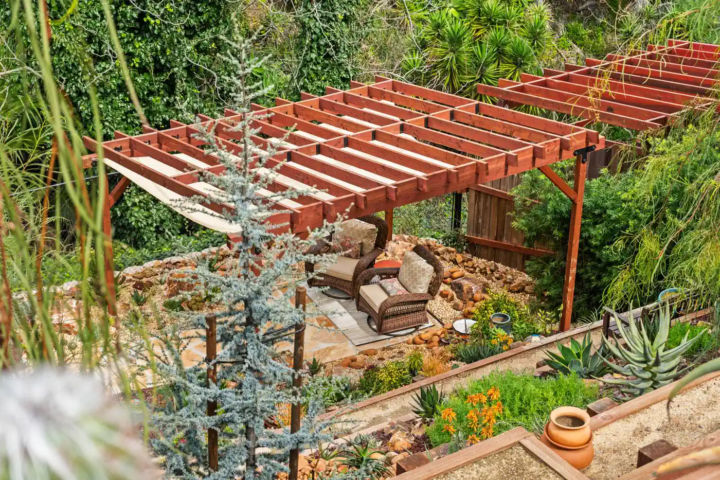 Redwood pergola built over a hillside seating terrace
