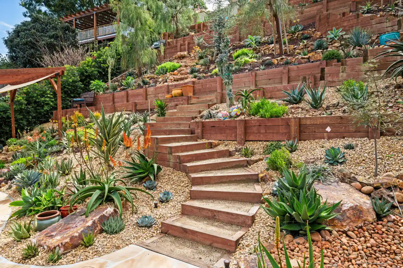 Wide stair run through a terraced hillside garden in bloom