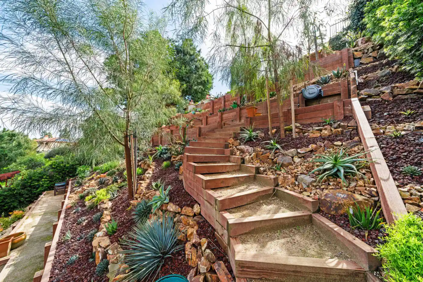 Multi-tiered hillside terraces with stairs and drought-tolerant planting